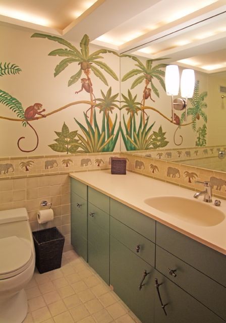 Bathroom - tropical beige tile bathroom idea in Chicago with an integrated sink, flat-panel cabinets, green cabinets, solid surface countertops and a one-piece toilet