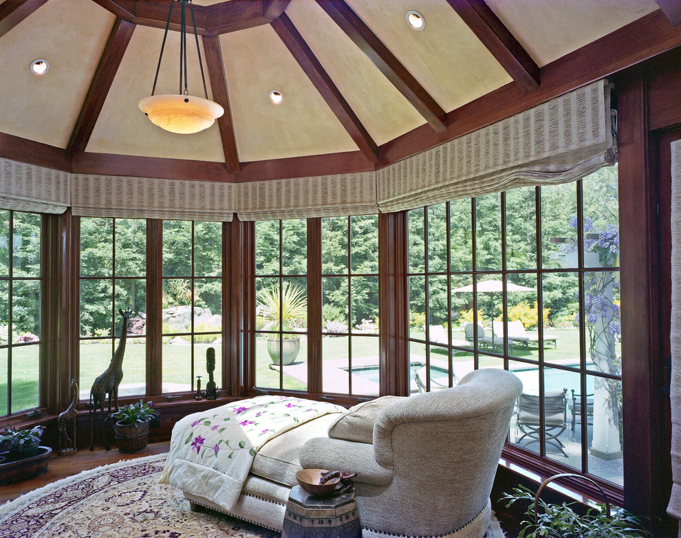 This is an example of a traditional sunroom in San Francisco with dark hardwood floors and a standard ceiling.