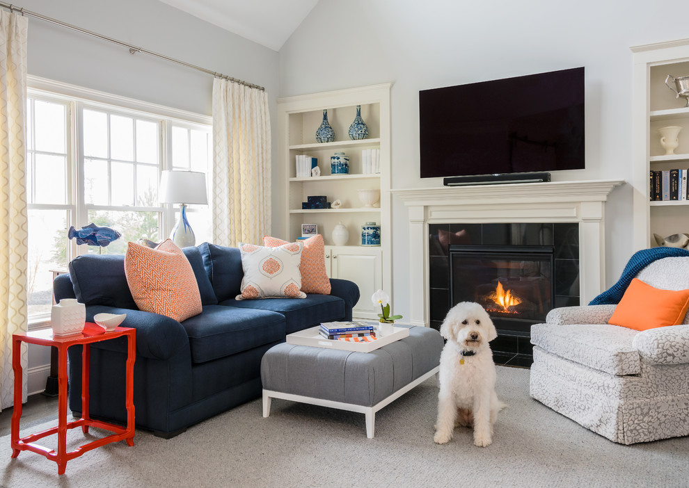 Design ideas for a traditional family room in Boston with grey walls, a standard fireplace and a tile fireplace surround.