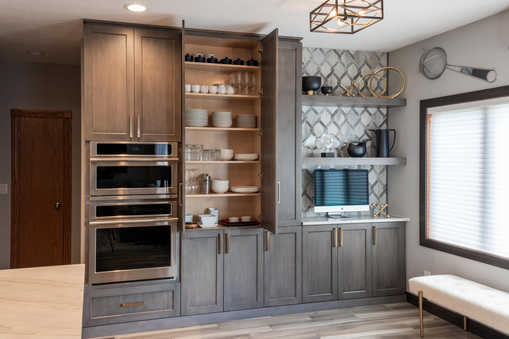 Kitchen - large transitional medium tone wood floor and brown floor kitchen idea with a single-bowl sink, flat-panel cabinets, gray cabinets, quartzite countertops, gray backsplash, marble backsplash, paneled appliances, an island and white countertops