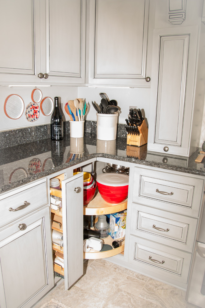 Example of a large transitional u-shaped porcelain tile and beige floor eat-in kitchen design in Milwaukee with an undermount sink, raised-panel cabinets, gray cabinets, granite countertops, white backsplash, marble backsplash, stainless steel appliances and no island