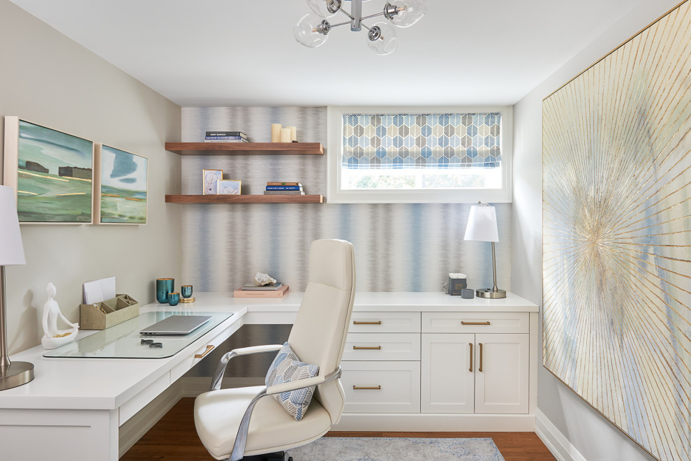 Transitional built-in desk medium tone wood floor, brown floor and wallpaper home office photo in Toronto with beige walls