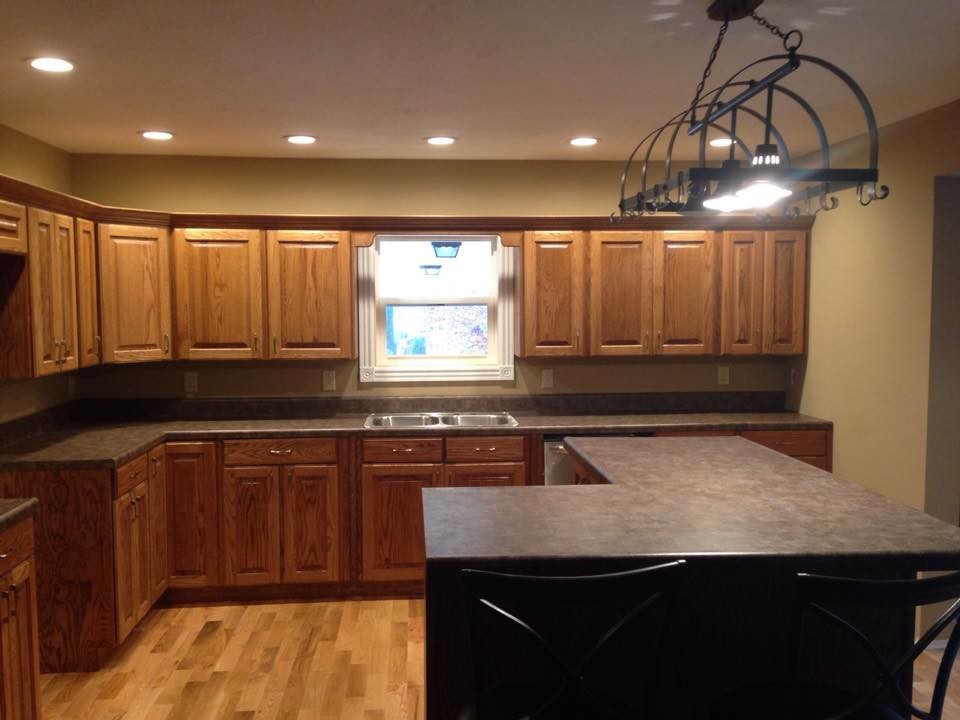 Inspiration for a light wood floor kitchen remodel in Huntington with recessed-panel cabinets, light wood cabinets, wood countertops and an island