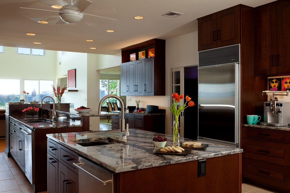 Inspiration for a large transitional galley porcelain tile kitchen pantry remodel with an undermount sink, flat-panel cabinets, medium tone wood cabinets, quartz countertops, brown backsplash, stainless steel appliances and two islands