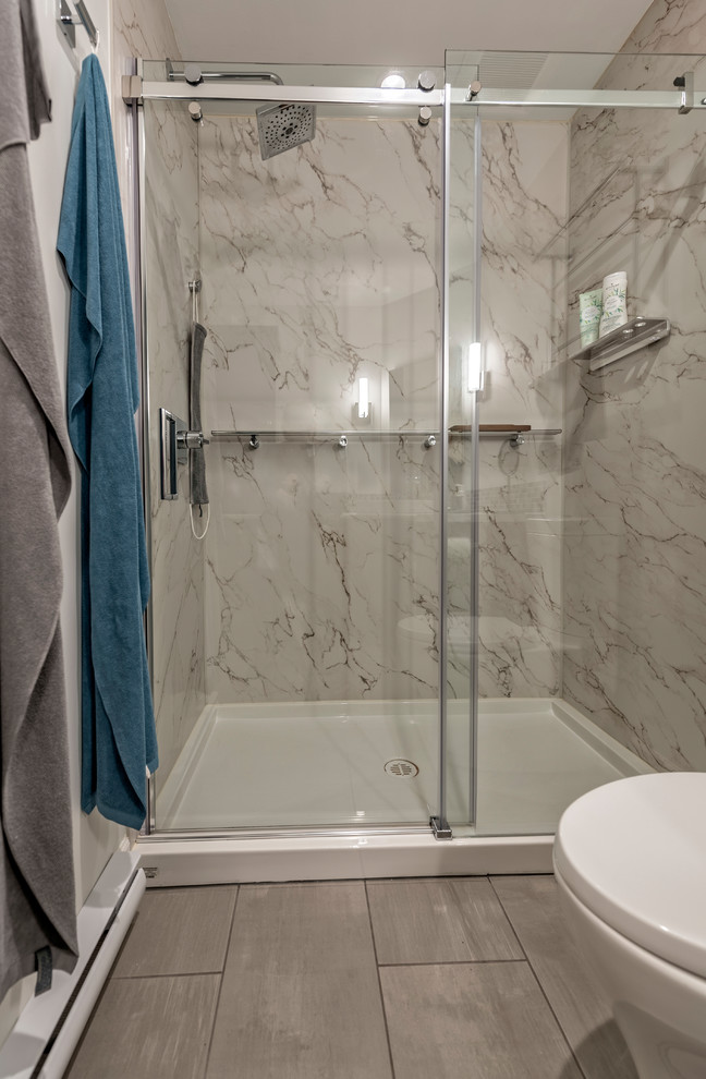 Inspiration for a mid-sized transitional 3/4 bathroom in Vancouver with shaker cabinets, grey cabinets, an alcove tub, an alcove shower, a two-piece toilet, multi-coloured tile, mosaic tile, grey walls, ceramic floors, a vessel sink, laminate benchtops, grey floor, a sliding shower screen and grey benchtops.