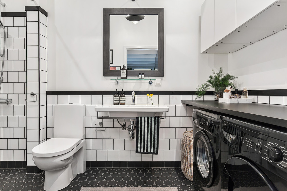 Inspiration for a mid-sized scandinavian master bathroom in Stockholm with a two-piece toilet, white tile, porcelain tile, white walls, mosaic tile floors, a wall-mount sink, laminate benchtops and a laundry.