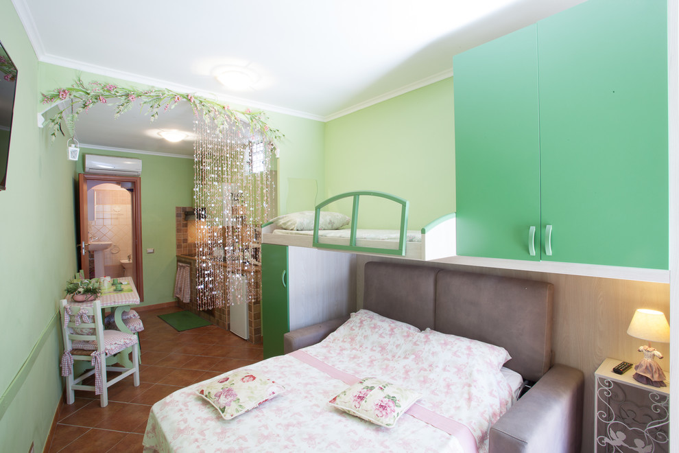 This is an example of a small contemporary loft-style bedroom in Rome with green walls.
