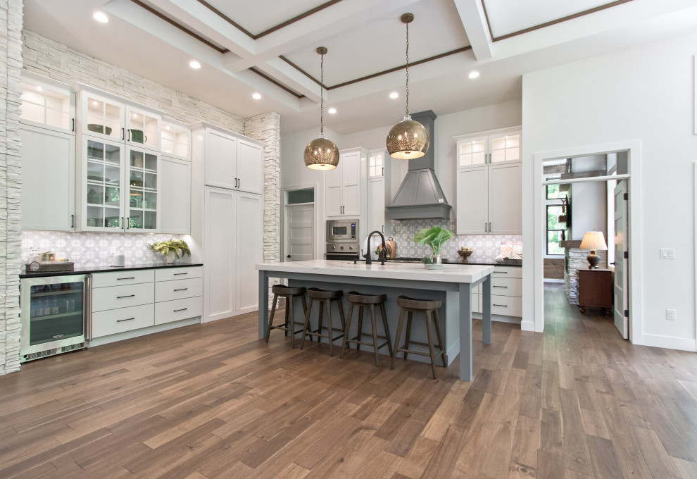 Inspiration for a transitional l-shaped open plan kitchen in Other with an undermount sink, recessed-panel cabinets, white cabinets, quartz benchtops, grey splashback, marble splashback, stainless steel appliances, medium hardwood floors, with island, brown floor, white benchtop and coffered.