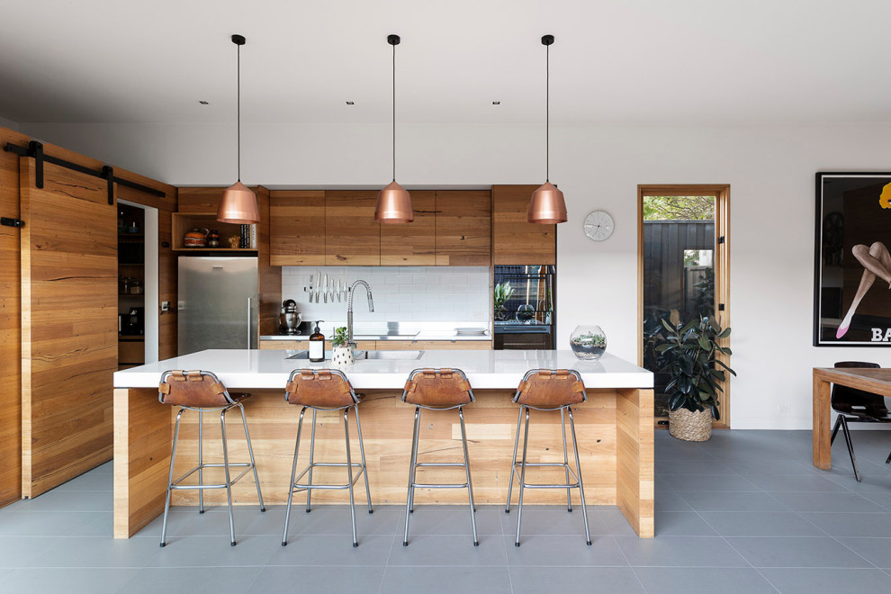 Inspiration for an eclectic kitchen in Melbourne with a double-bowl sink, black appliances, ceramic floors and grey floor.