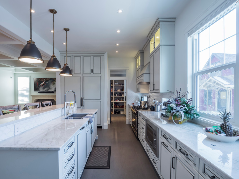 Design ideas for a mid-sized transitional l-shaped open plan kitchen in Edmonton with a double-bowl sink, beaded inset cabinets, distressed cabinets, granite benchtops, white splashback, porcelain splashback, panelled appliances and with island.