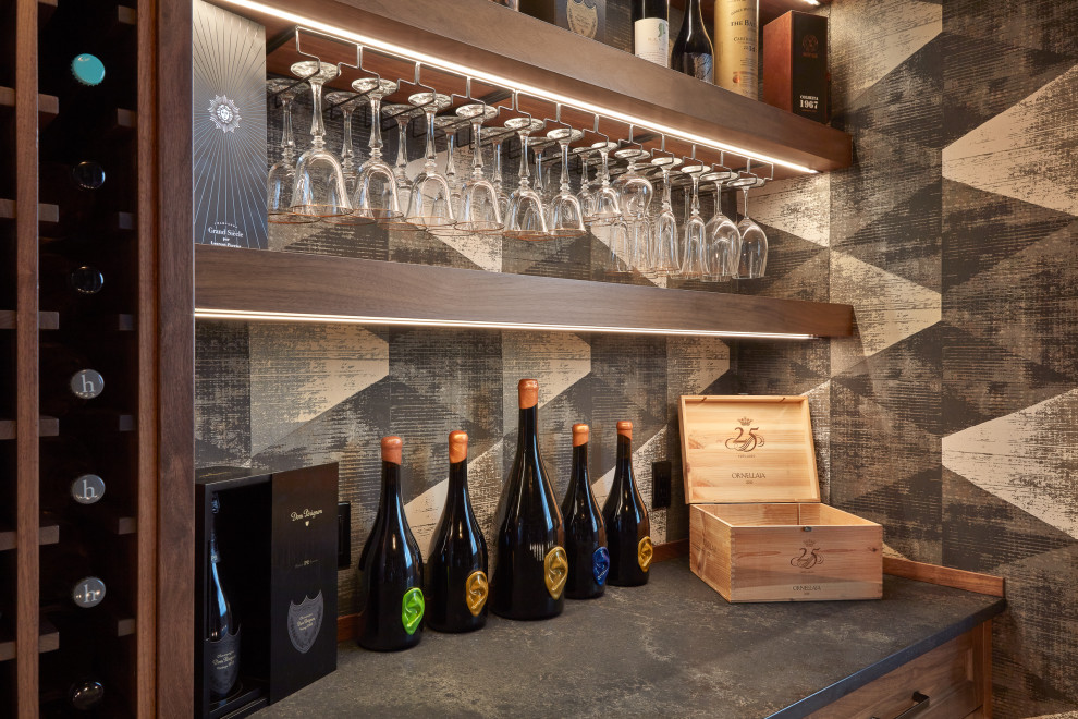 Wine cellar - mid-sized industrial light wood floor and beige floor wine cellar idea in Edmonton with display racks