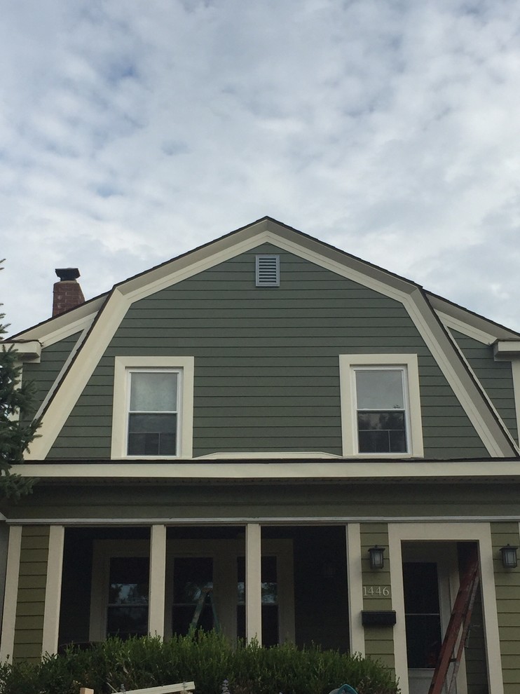This is an example of a large traditional two-storey green exterior in Columbus with concrete fiberboard siding.