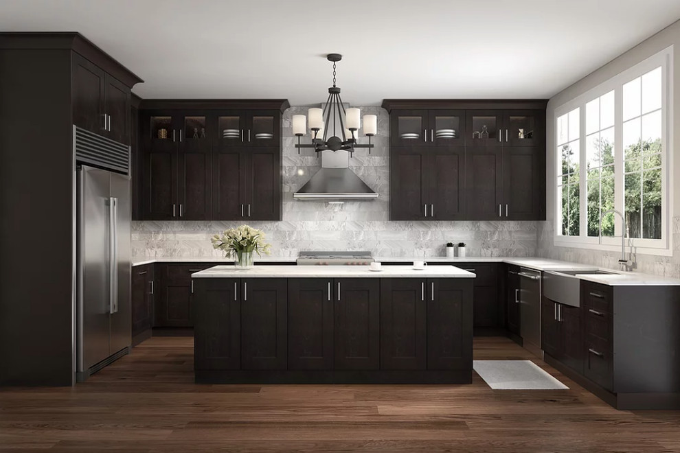 This is an example of a mid-sized transitional u-shaped eat-in kitchen in Miami with an undermount sink, shaker cabinets, dark wood cabinets, quartz benchtops, grey splashback, porcelain splashback, stainless steel appliances, laminate floors, with island, brown floor, white benchtop and vaulted.