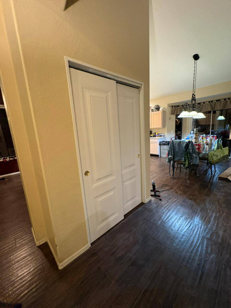 Inspiration for a mid-sized modern dark wood floor and brown floor hallway remodel with white walls