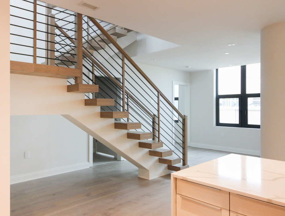 Design ideas for a large contemporary wood u-shaped staircase in DC Metro with cable railing.