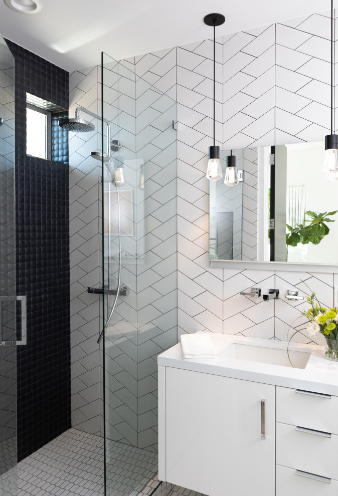 Mid-sized contemporary 3/4 bathroom in Orange County with flat-panel cabinets, white cabinets, black and white tile, porcelain tile, porcelain floors, an undermount sink, engineered quartz benchtops, white floor, a hinged shower door, white benchtops and an alcove shower.
