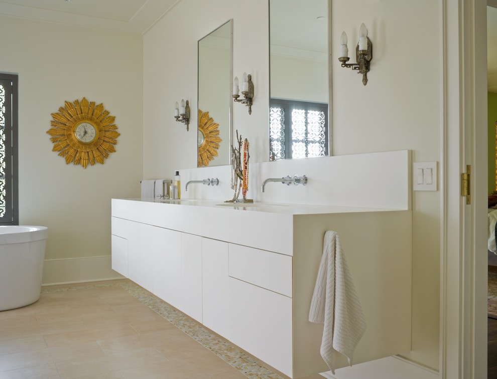 Photo of a mediterranean bathroom in Seattle with flat-panel cabinets, white cabinets, a freestanding tub and white walls.
