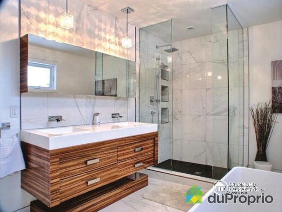 Mid-sized contemporary master bathroom in Montreal with a freestanding tub, a double shower, ceramic tile, marble floors, an integrated sink, flat-panel cabinets, medium wood cabinets, solid surface benchtops, white tile and white walls.