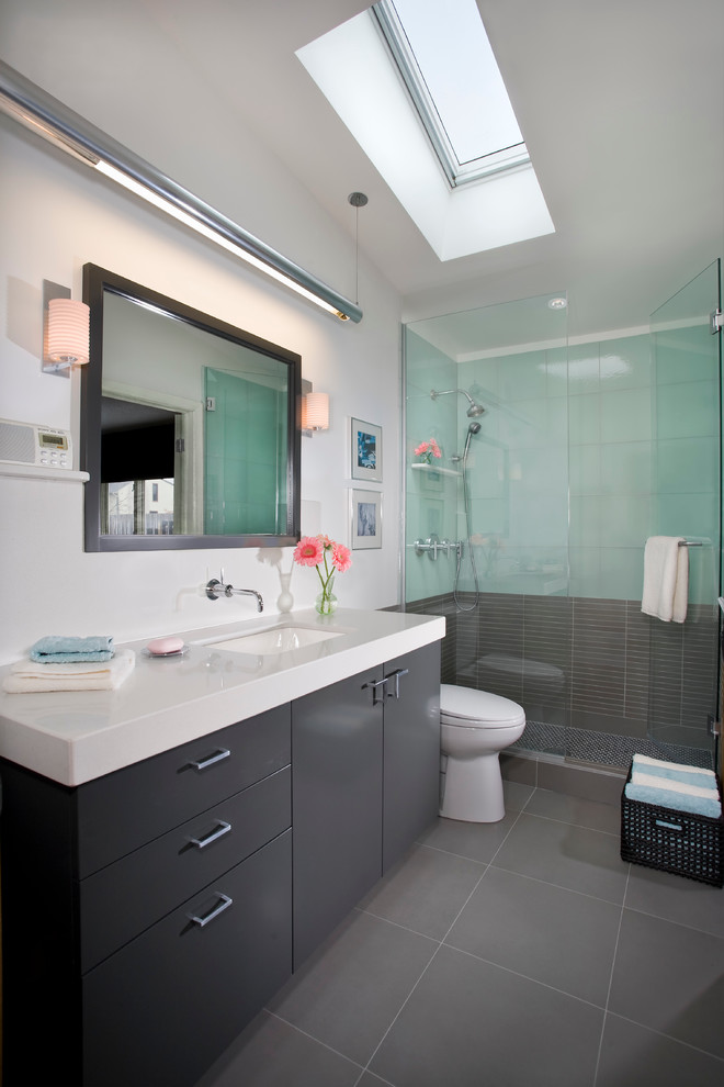 Photo of a contemporary bathroom in Minneapolis with an undermount sink, flat-panel cabinets, grey cabinets, an alcove shower and grey floor.