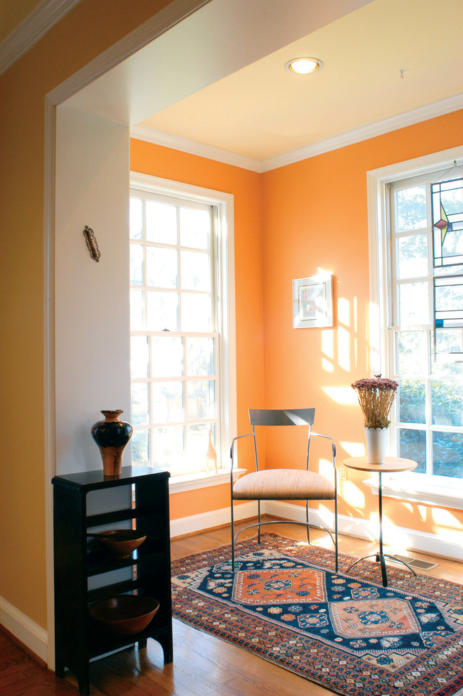 Inspiration for a contemporary family room in DC Metro with orange walls and medium hardwood floors.