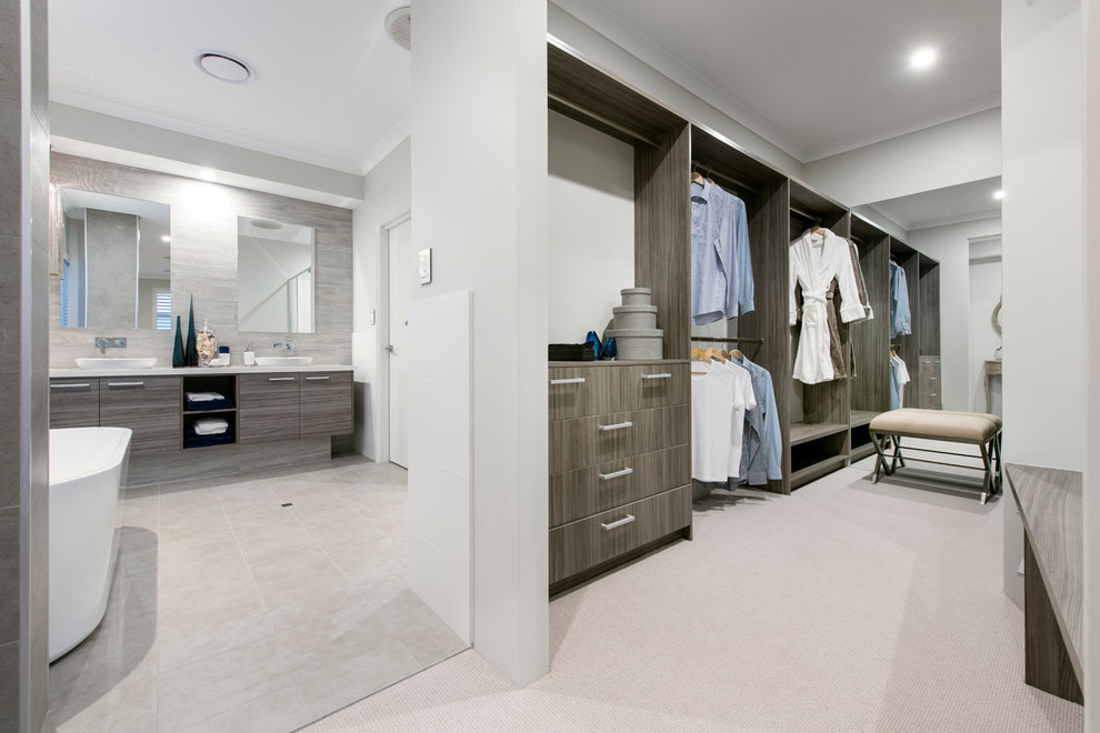 Inspiration for a large beach style storage and wardrobe in Perth with carpet.