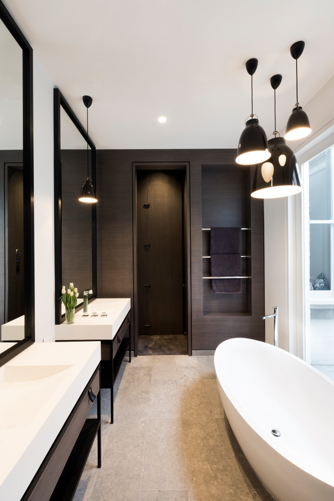 Inspiration for a mid-sized contemporary master bathroom in Melbourne with a freestanding tub, white tile, porcelain tile, porcelain floors, soapstone benchtops, white benchtops, a double vanity, a freestanding vanity, flat-panel cabinets, a console sink and grey floor.