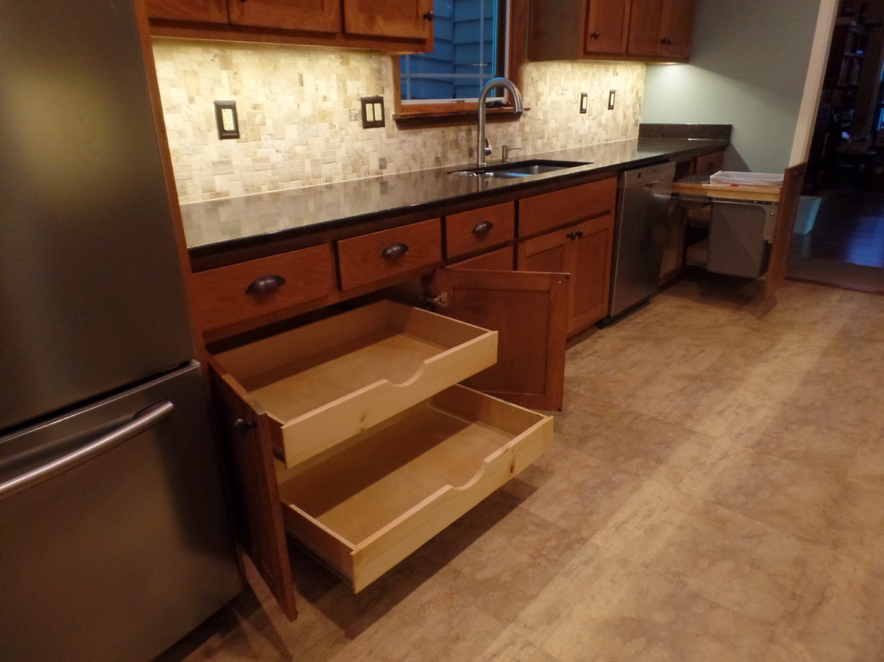 Mid-sized transitional galley home design photo with an undermount sink, shaker cabinets, medium tone wood cabinets, quartz countertops, multicolored backsplash, travertine backsplash, colored appliances and no island