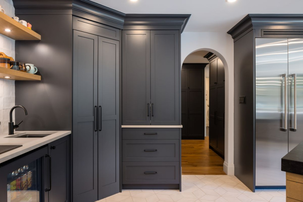 Example of a mid-sized transitional u-shaped porcelain tile and white floor open concept kitchen design in Vancouver with an undermount sink, shaker cabinets, gray cabinets, granite countertops, white backsplash, porcelain backsplash, stainless steel appliances, a peninsula and black countertops