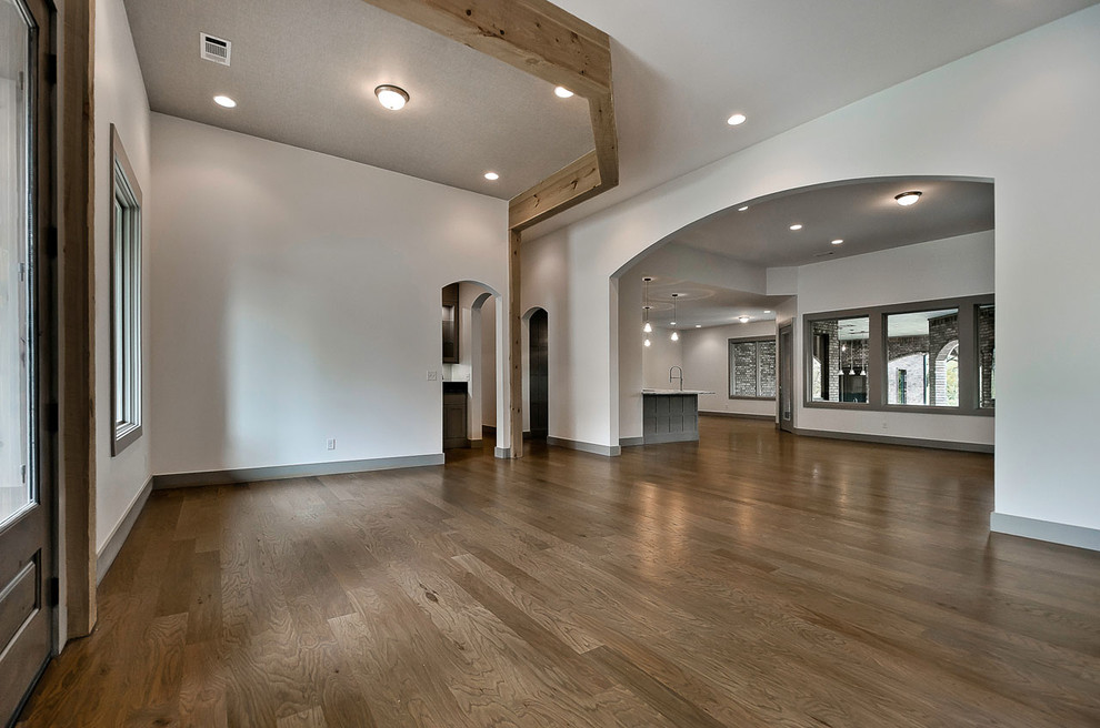 Inspiration for a modern medium tone wood floor front door remodel with white walls and a glass front door