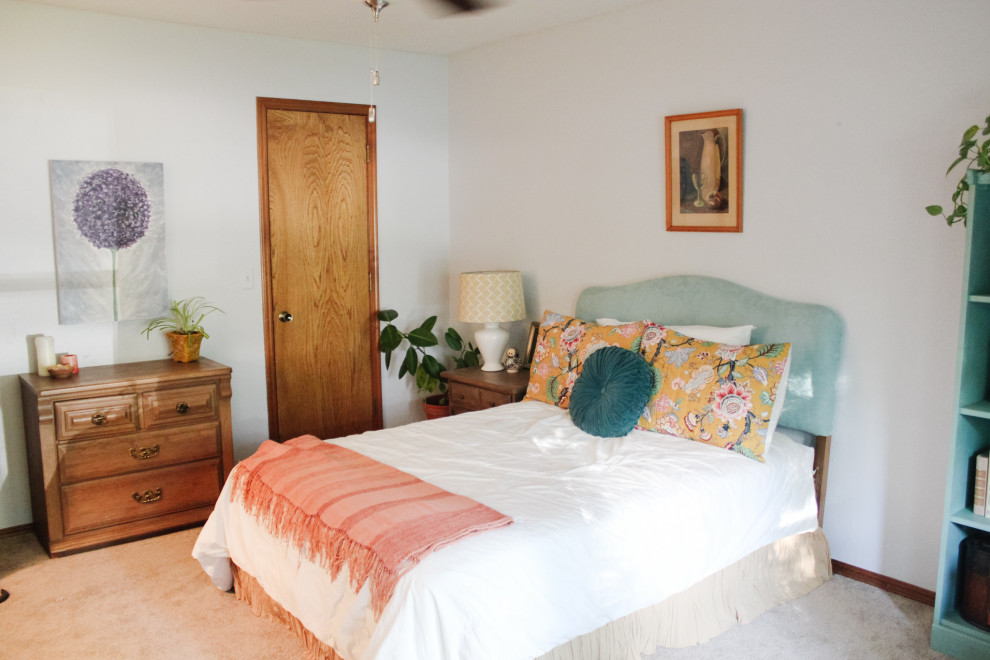 This is an example of a medium sized bohemian guest bedroom in Hawaii with white walls, carpet and beige floors.