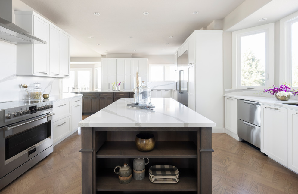 Large transitional l-shaped light wood floor enclosed kitchen photo in Denver with a double-bowl sink, shaker cabinets, gray cabinets, quartz countertops, white backsplash, quartz backsplash, stainless steel appliances, two islands and white countertops