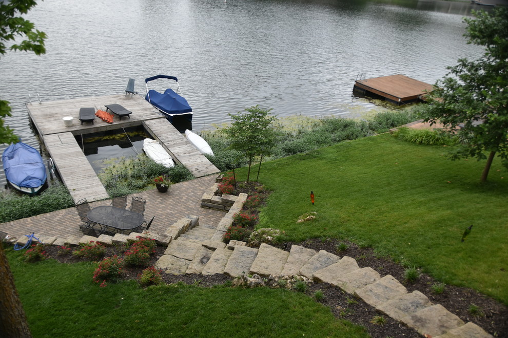 Inspiration for a small contemporary partial sun hillside stone landscaping in Kansas City.