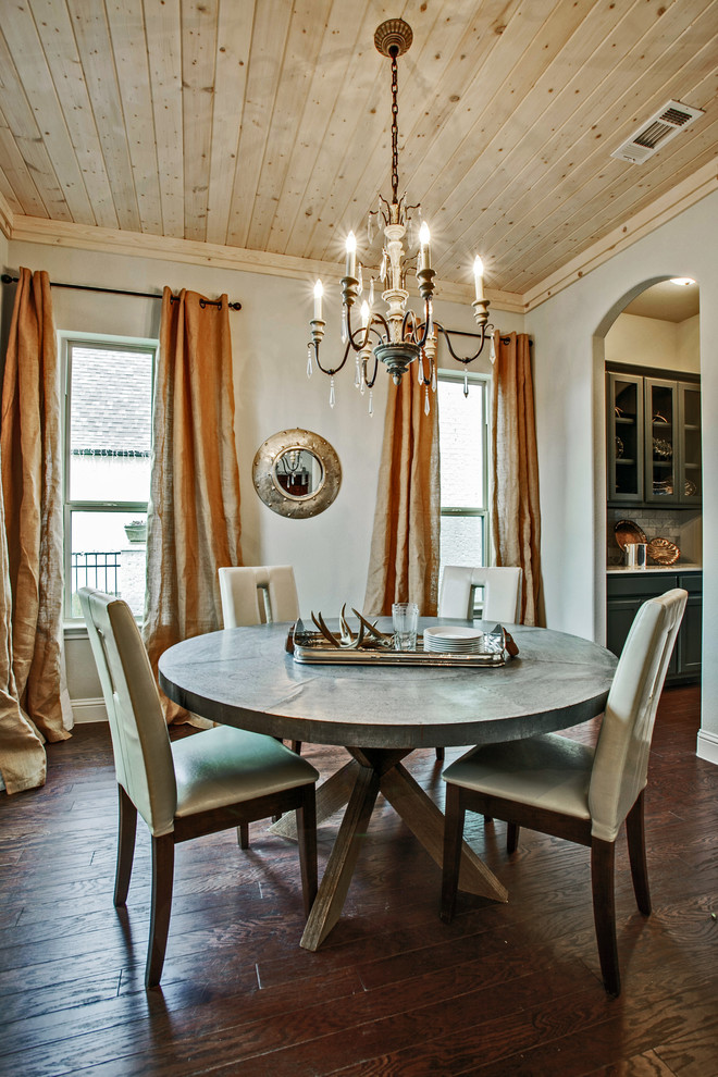 Inspiration for a traditional dining room in Dallas with grey walls and dark hardwood floors.