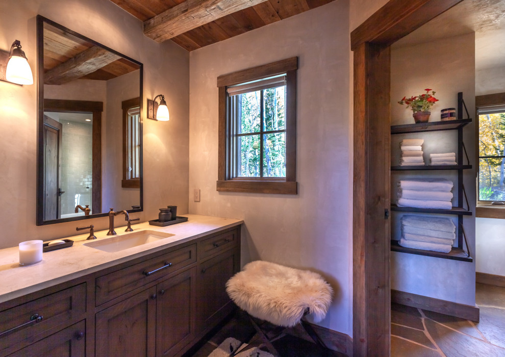 Design ideas for a large country 3/4 bathroom in Denver with shaker cabinets, dark wood cabinets, an alcove tub, a shower/bathtub combo, white tile, subway tile, grey walls, slate floors, an undermount sink, black floor, a hinged shower door, beige benchtops and a built-in vanity.