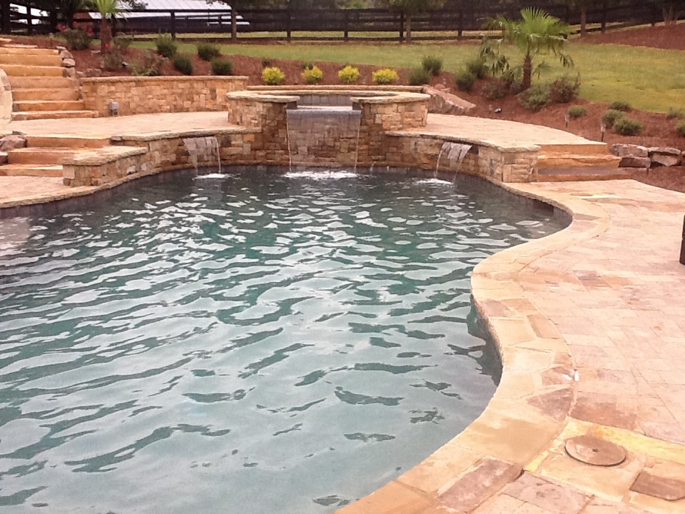 Design ideas for a large country natural pool in Atlanta with a water feature.