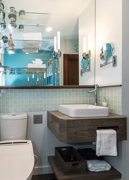 Small transitional master bathroom in St Louis with a vessel sink, open cabinets, medium wood cabinets, wood benchtops, a two-piece toilet, blue tile, glass tile and blue walls.