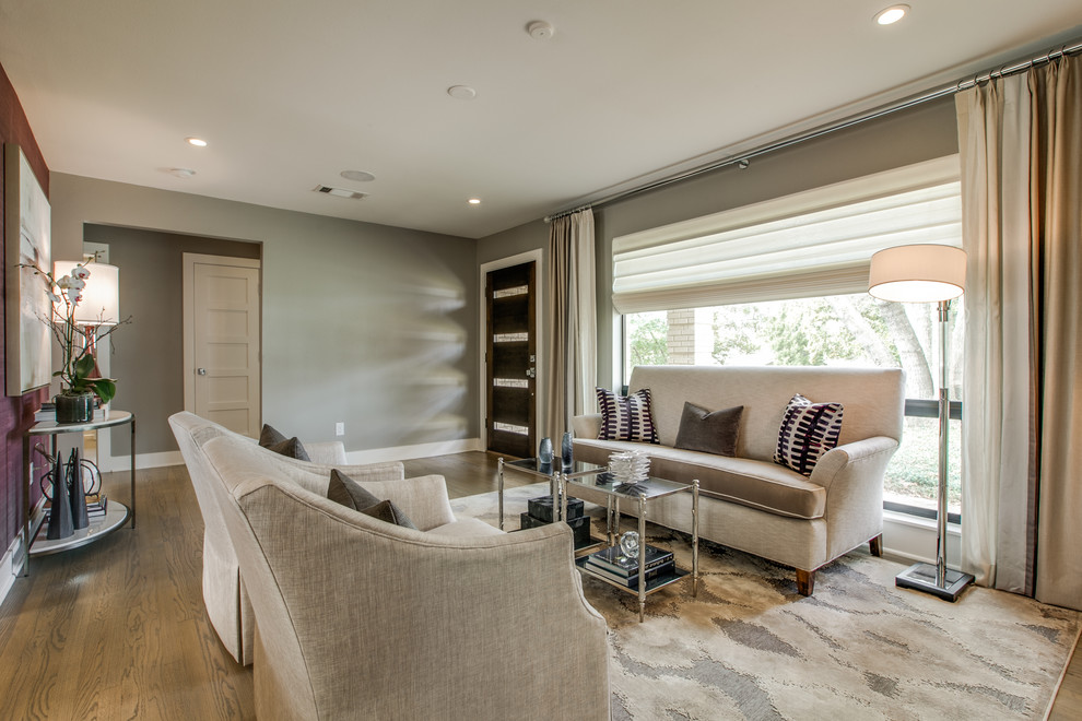 Mid-sized transitional formal open concept living room in Dallas with grey walls, light hardwood floors and no tv.