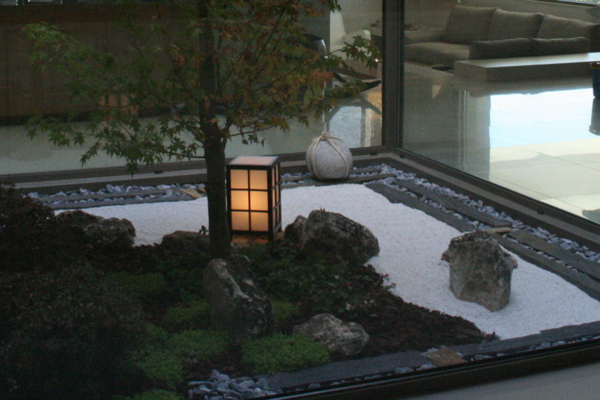 This is an example of a small asian courtyard shaded formal garden in London.