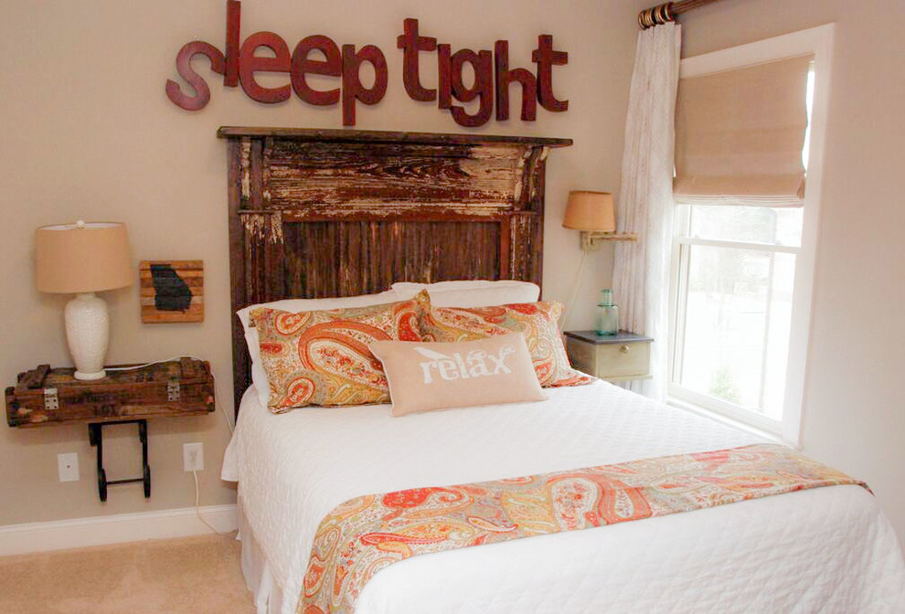 This is an example of a mid-sized country guest bedroom in Atlanta with beige walls and carpet.