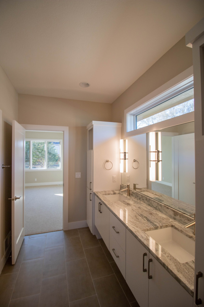 Bathroom - transitional master porcelain tile porcelain tile and double-sink bathroom idea in Omaha with flat-panel cabinets, white cabinets, an undermount sink, marble countertops and a floating vanity