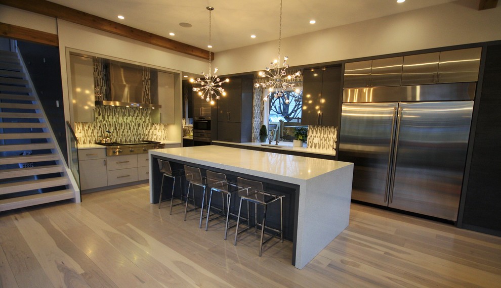 Large trendy single-wall medium tone wood floor and brown floor eat-in kitchen photo in Chicago with an undermount sink, flat-panel cabinets, brown cabinets, quartz countertops, multicolored backsplash, stainless steel appliances, an island and white countertops