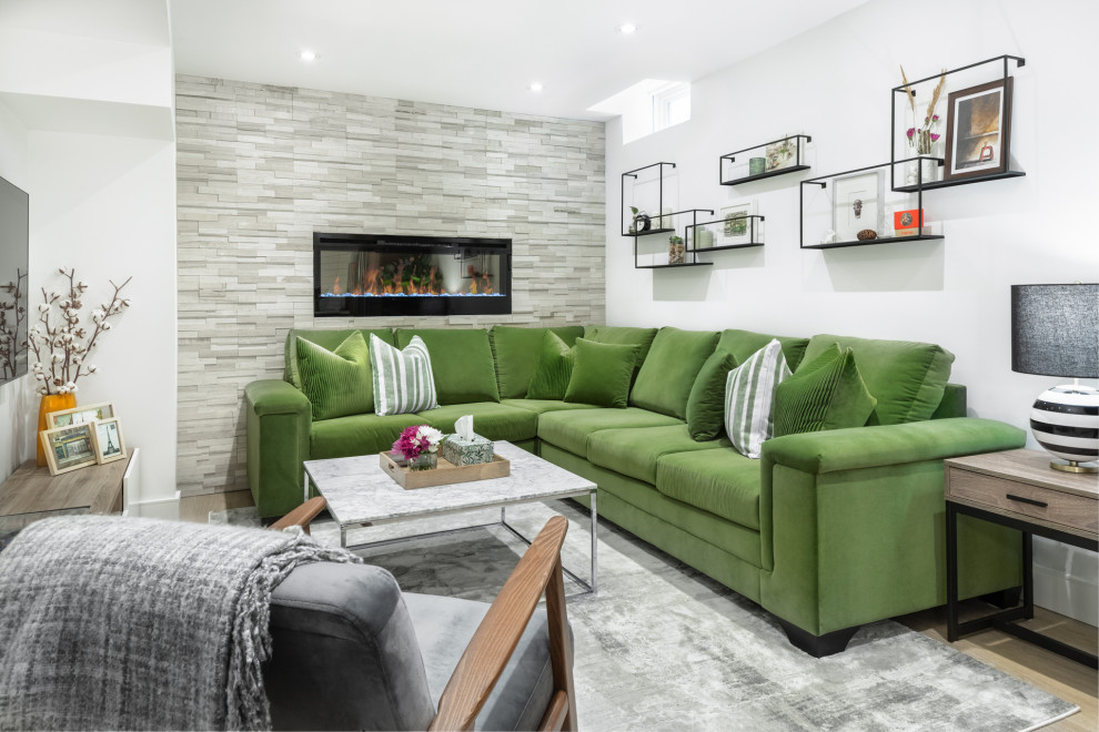 Basement - mid-sized contemporary enclosed and look-out light wood floor and beige floor basement idea in Toronto with white walls, a stone fireplace, a wall-mounted tv and a ribbon fireplace