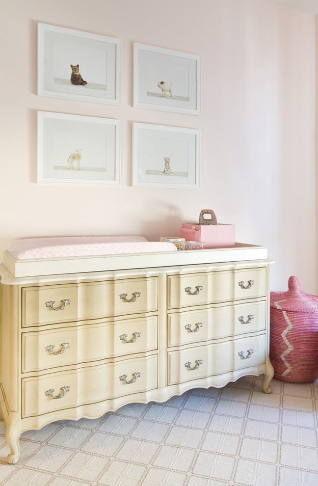 Large transitional kids' bedroom in Los Angeles with pink walls and carpet for girls.