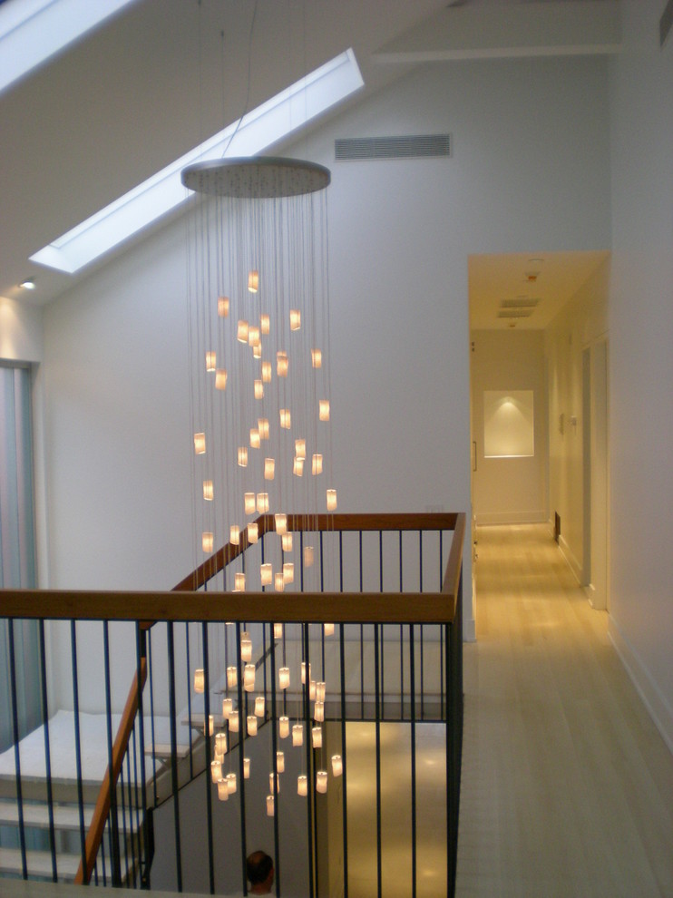 This is an example of a mid-sized contemporary wood l-shaped staircase in New York.