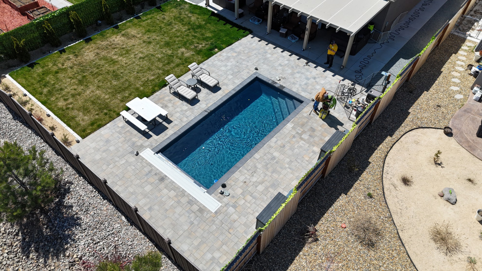 Example of a small backyard brick and rectangular pool design