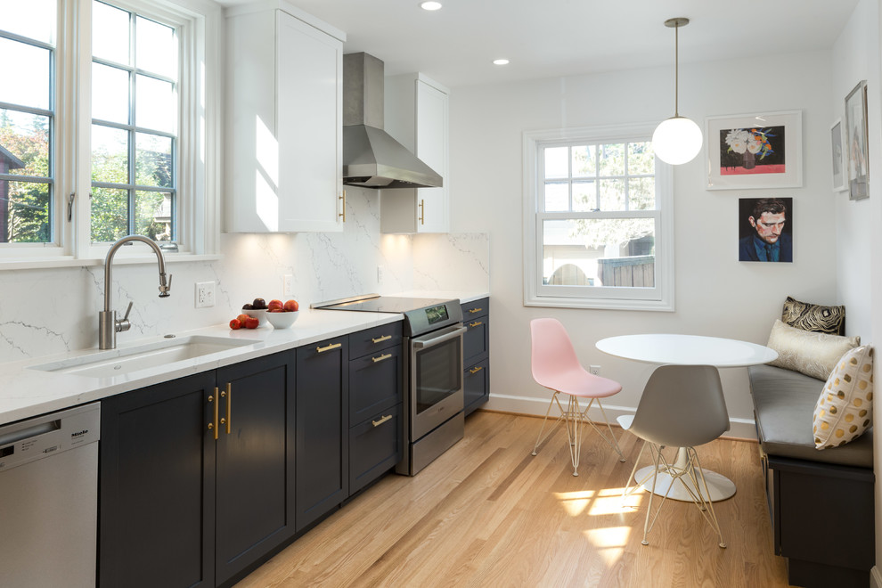 Transitional single-wall eat-in kitchen in Portland with an undermount sink, shaker cabinets, blue cabinets, white splashback, stainless steel appliances, medium hardwood floors, no island and brown floor.