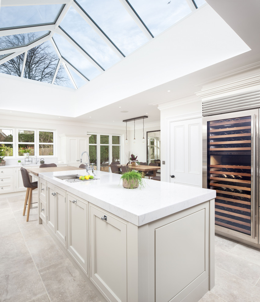 This is an example of a large contemporary kitchen in Other with quartzite benchtops, stainless steel appliances, a peninsula and white benchtop.