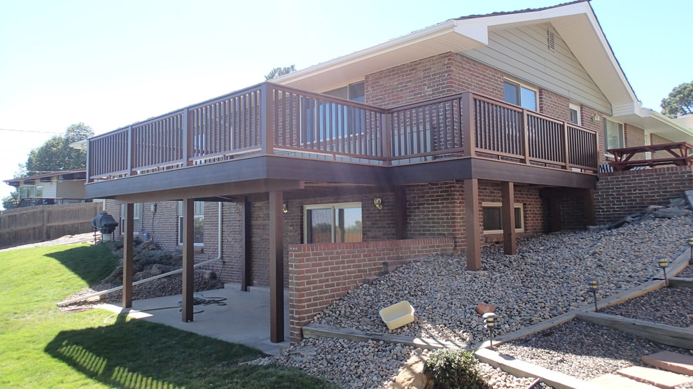 This is an example of a large traditional backyard deck in Denver with no cover.