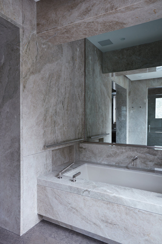 Inspiration for a transitional master bathroom in San Francisco with an alcove tub, gray tile, marble, grey walls and grey floor.