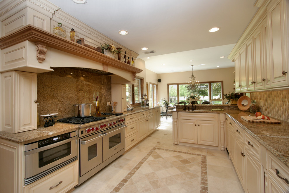 Photo of a country u-shaped kitchen in Miami with raised-panel cabinets, beige cabinets, beige splashback and stainless steel appliances.